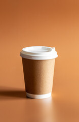 Zero Waste Lifestyle, Craft Disposable Brown Cup with white Plastic Lid on brown background isolated.