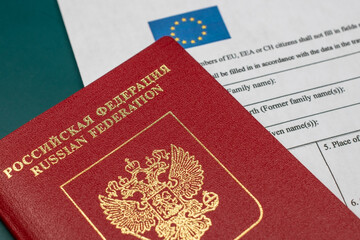 Russian travel passport with Schengen visa application form, sanctions, emigration, immigration, tourism concept