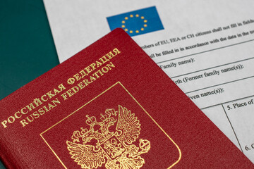 Russian travel passport with Schengen visa application form, sanctions, emigration, immigration, tourism concept
