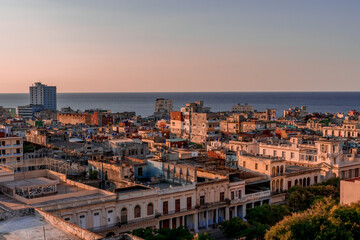 Fototapeta na wymiar View over the rooftops of Havana in Cuba at sunset with the sea