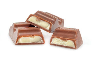 Pieces of chocolate with soft milk filling on a white background. Chocolate bar. Pastry