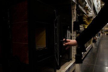 The girl opens a new fireplace in the store
