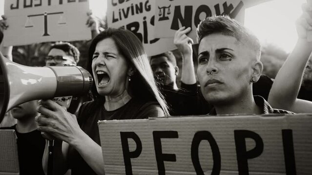 Demonstration of multiracial activists protesting against financial crisis and global inflation - Economic justice activism concept - Black and white editing