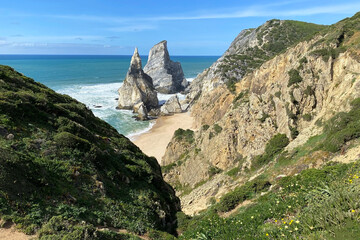 Panorama of the ocean coast and rock bay, Atlantic Ocean, beautiful cloudscape, dramatic landscape, colorful seascape with sheer rocks, travel content, Lisbon, Portugal