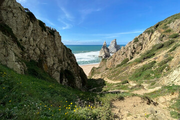 Panorama of the ocean coast and rock bay, Atlantic Ocean, beautiful cloudscape, dramatic landscape, colorful seascape with sheer rocks, travel content, Lisbon, Portugal