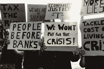 People protesting against financial crisis and global inflation - Economic justice activism concept - Black and white editing - obrazy, fototapety, plakaty