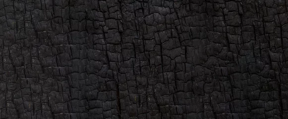 Papier Peint photo Texture du bois de chauffage Burned wood texture. Black background, Details on the surface of charcoal, burnt wood texture, Grunge, burning fire, Dark material.