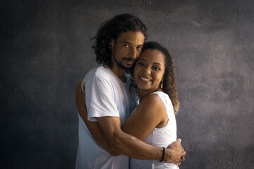 romantic couple of lovers with black background playing and caressing