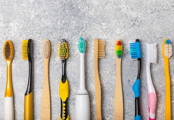 Electric toothbrush and manual toothbrush on marble cement background. Oral hygiene. Dental care.Dentistry concept.Place for text.Place for copy.