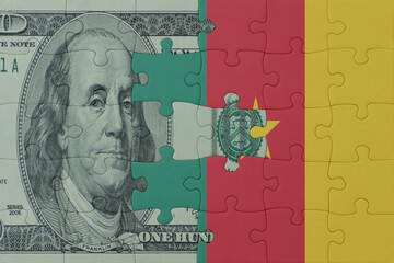 puzzle with the national flag of cameroon and dollar money banknote. macro.concept.