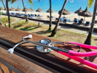 Medical stethoscope on the beach at sea in summer