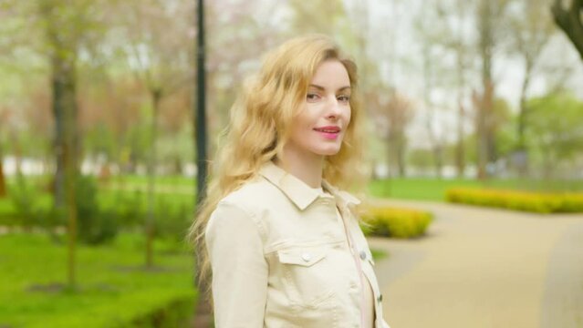 Walking, outdoor and woman in park for health, peace, rest and relax outside. Carefree positive smiling female lady walk in nature having fun, fresh air for balance, break, awareness and energy.