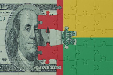 puzzle with the national flag of guinea bissau and dollar money banknote. macro.concept.