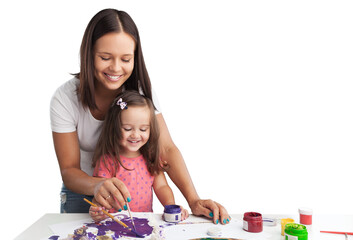 Happy young mother and daughter painting