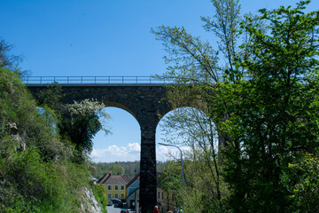 Historic stone railway viaduct on a sunny day against a blue sky
