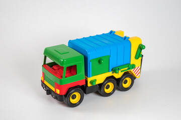 Multi-colored plastic children's toy cars on a white background.