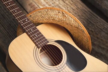 Acoustic guitar, against a wooden plank background