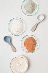 Homemade cosmetics and clay facial mask. Zero waste, eco friendly diy beauty products ingredients on light background, flat lay, top view