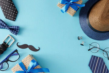 Celebrate Father's Day in trendy style with top view flat lay of gift boxes with bows black paper mustache and men's accessories on light blue background with empty space for text or advert