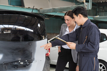 Car mechanic service and maintenance auto body concept. Male mechanic and female car owner customer...