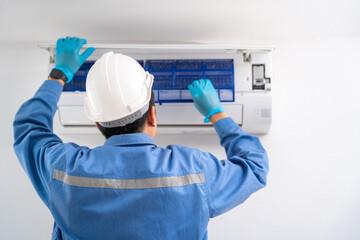 Air technician service cleaning air conditioner indoors. Service concept of an air conditioner...