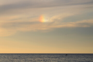 A mini rainbow in the sky as a result of the refraction of light over the Mediterranean Sea. 