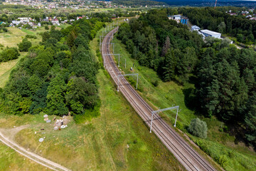 Aerial view of railway tracks surrounded by green landscape