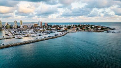 Fototapeta na wymiar aerial of Punta del Este city Uruguay Atlantic coastline with scenic skyscraper building and skyline drone footage golden hours