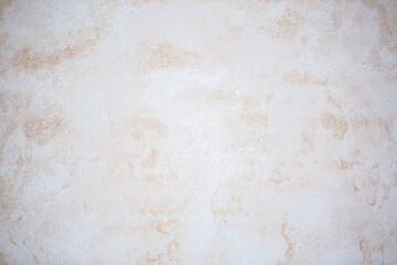 Light background of decorative plaster with abstract spots. Unusual texture of white or gray wall with beautiful patterns, creative surface background. Finishing coating for building cladding.