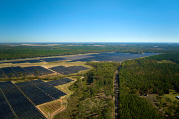 Aerial view of big sustainable electric power plant with many rows of solar photovoltaic panels for producing clean electrical energy. Renewable electricity with zero emission concept