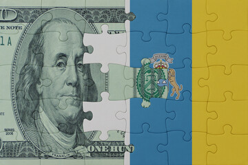 puzzle with the national flag of canary islands and dollar money banknote. macro.concept.