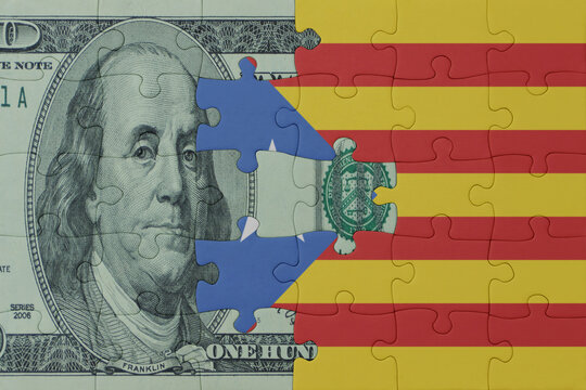 puzzle with the national flag of catalonia and dollar money banknote. macro.concept.