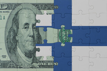 puzzle with the national flag of finland and dollar money banknote. macro.concept.