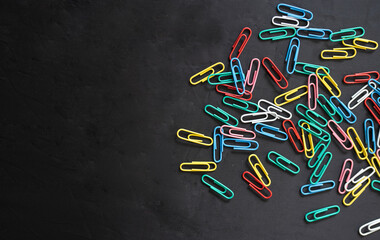 National Paperclip Day concept image, Paperclips isolated on black background