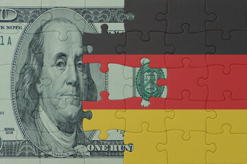 puzzle with the national flag of germany and dollar money banknote. macro.concept.