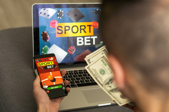 Businessman using smartphone against gambling app screen