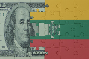 puzzle with the national flag of lithuania and dollar money banknote. macro.concept.