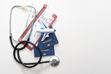 health insurance in travel concept. medical care abroad. stethoscope, toy airplane and passports