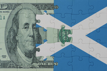 puzzle with the national flag of scotland and dollar money banknote. macro.concept.