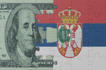puzzle with the national flag of serbia and dollar money banknote. macro.concept.