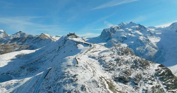 Aerial drone flyover Gornergrat with Matterhorn view during winter in Switzerland. Majestic mountain peaks iconic famous zermatt travel ski resort in the alps. Wonderful inspiring nature landscape.