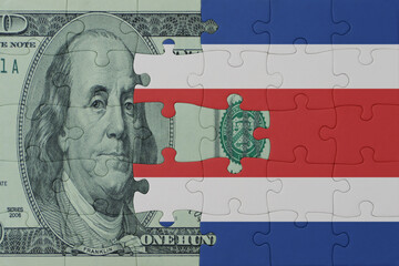 puzzle with the national flag of costa rica and dollar money banknote. macro.concept.