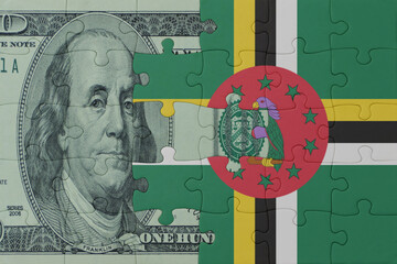 puzzle with the national flag of dominica and dollar money banknote. macro.concept.