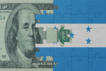 puzzle with the national flag of honduras and dollar money banknote. macro.concept.