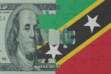 puzzle with the national flag of saint kitts and nevis and dollar money banknote. macro.concept.