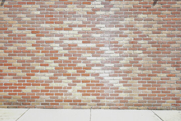 Muted tones brick wall and white sidewalk