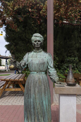 The Statue of Marie Curie Holding her Science Project
