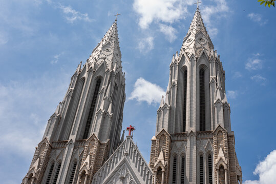 Exterior facade of a neo gothic church with and cloudy sky in background
