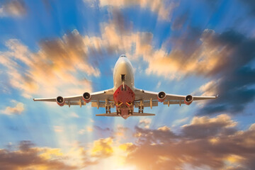 Airplane landing approach flies into the distance the sunrise sky is beautifully brightly lit rays divine.