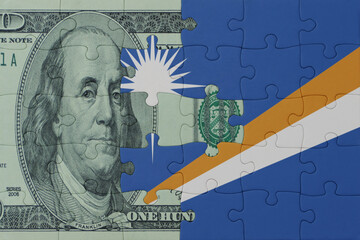 puzzle with the national flag of Marshall Islands and dollar money banknote. macro.concept.